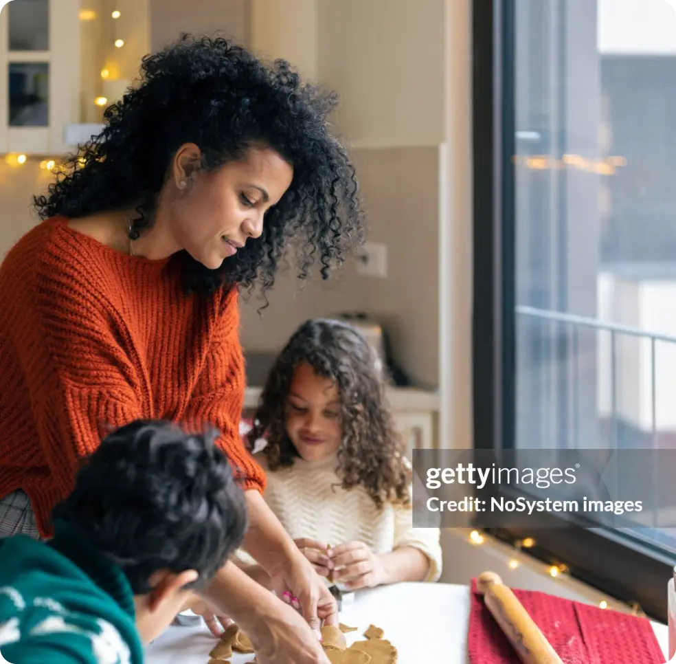 Family bakes cookies by a window.