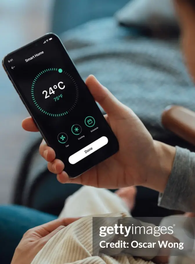 A person checking the temperature of their house on their phone